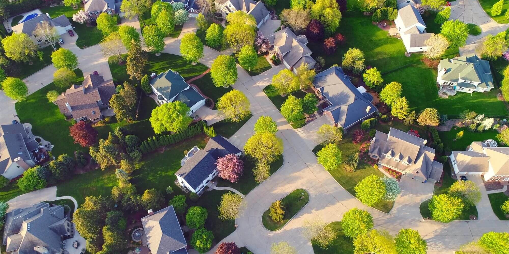 Aerial view of a suburban neighborhood at golden hour